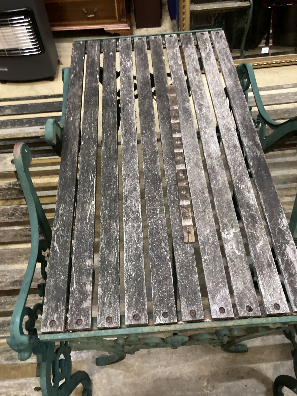 Four cast metal slatted wood garden armchairs and matching rectangular table, table 126 x 67cm, height 65cm